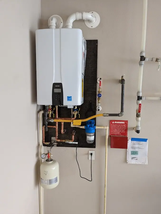 Professional plumber installing copper piping in a Haverhill home